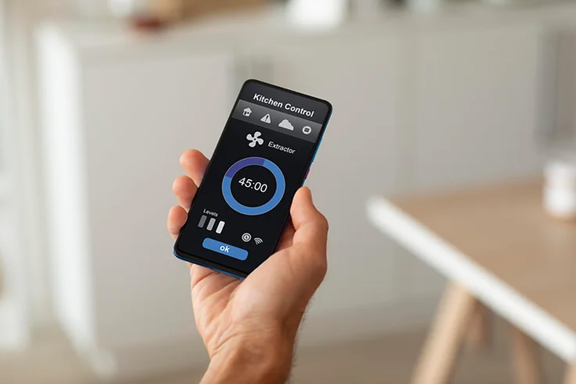 closeup of hand holding a smartphone with thermostat controls connected to it