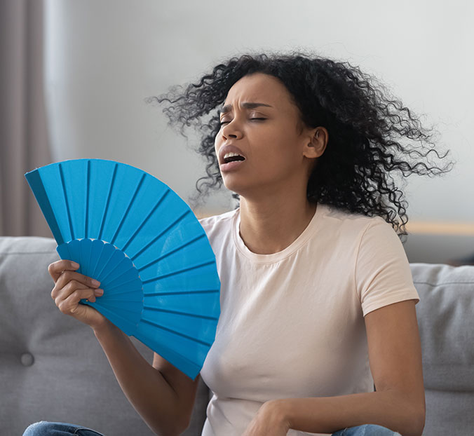woman fanning herself due to cooling loss