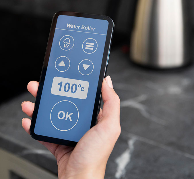 close up of hand holding a wifi enabled smart phone thermostat