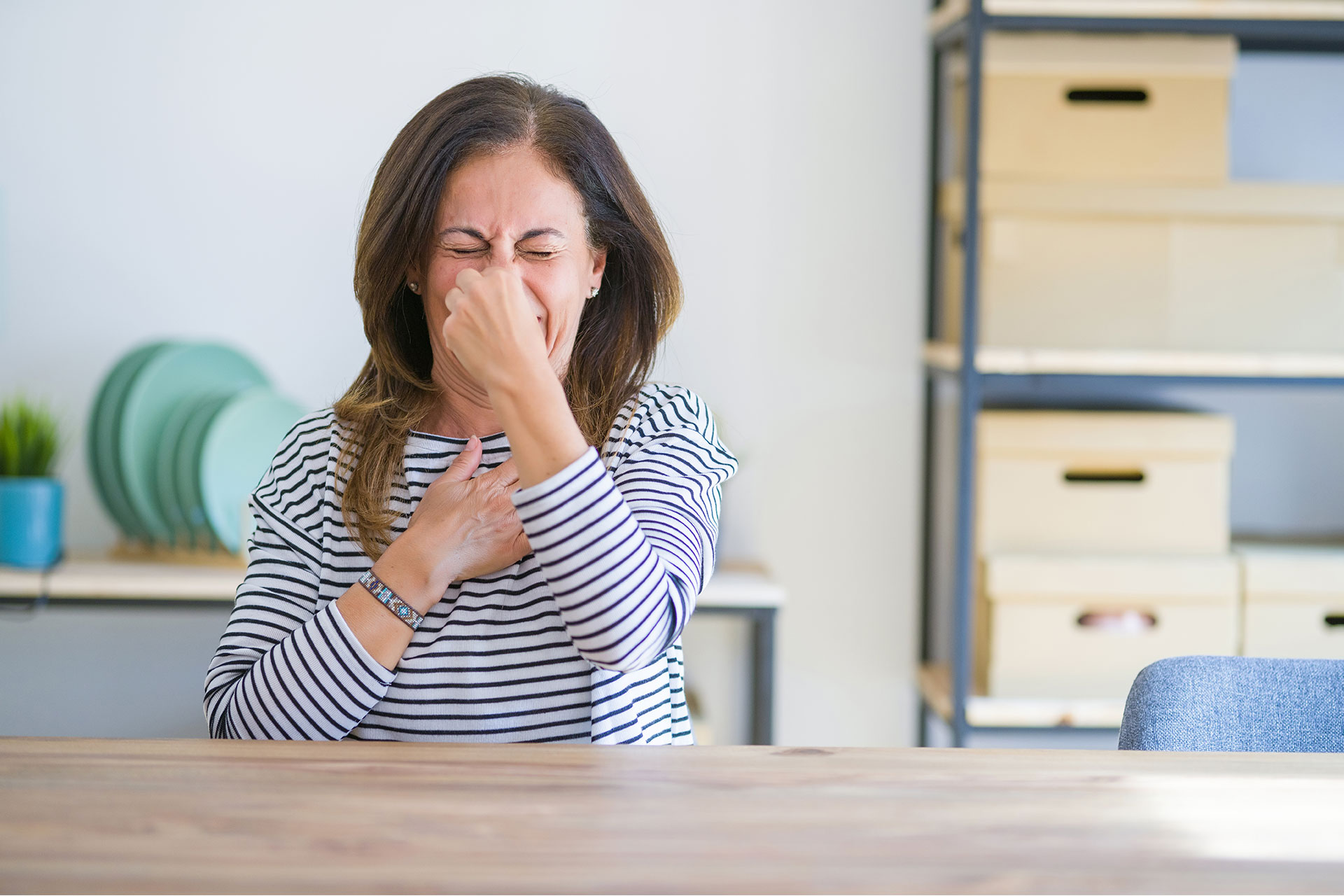 woman holding her nose due to rotten egg smell from boiler leak