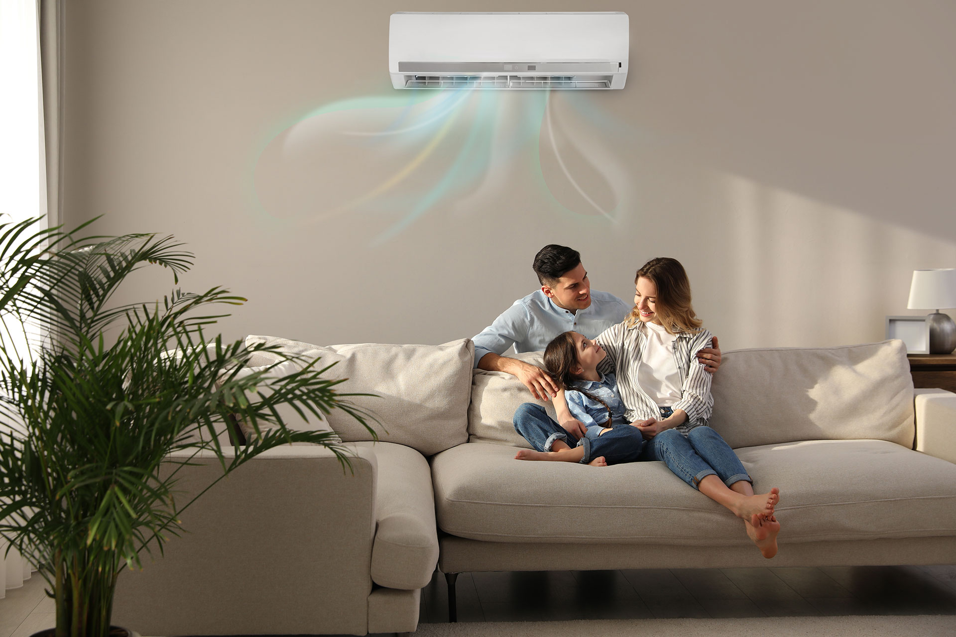 family on couch enjoying cooling from a ductless mini split system